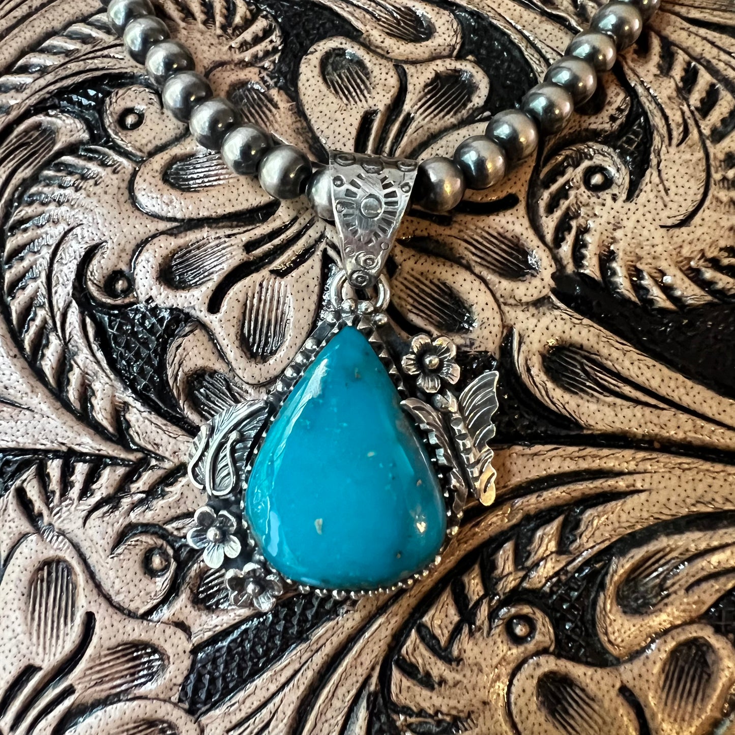 Kingman Turquoise Teardrop Pendant – Sterling Silver Floral Detail