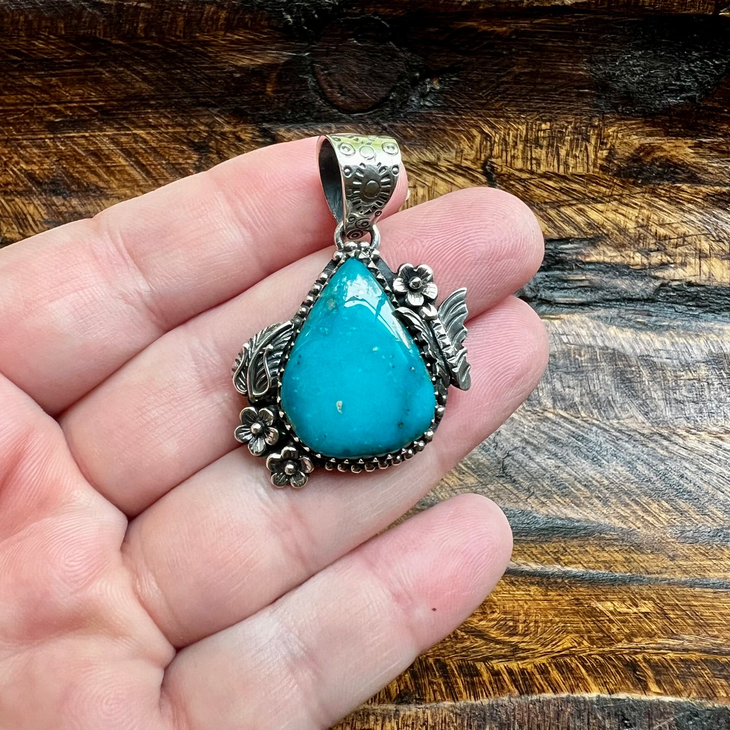 Kingman Turquoise Teardrop Pendant – Sterling Silver Floral Detail