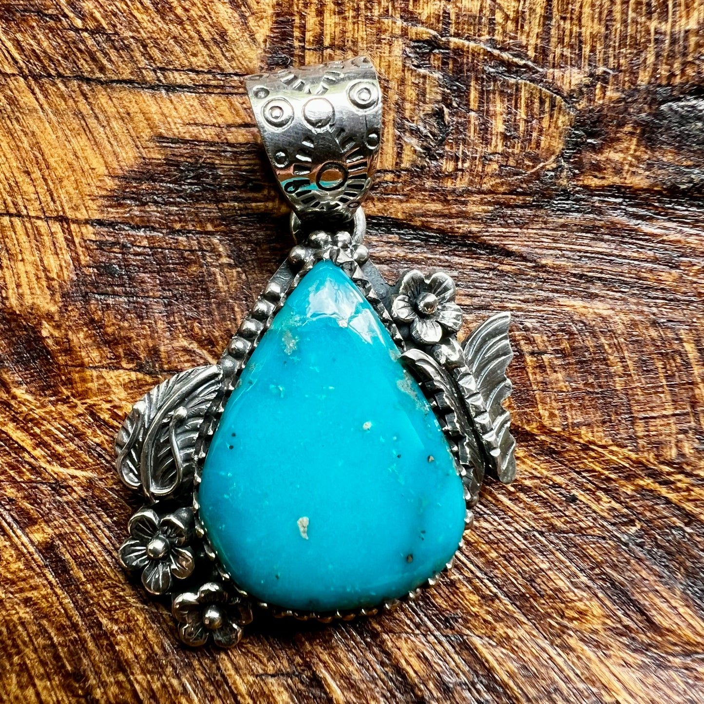 Kingman Turquoise Teardrop Pendant – Sterling Silver Floral Detail