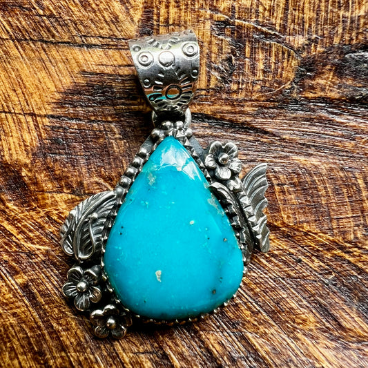 Kingman Turquoise Teardrop Pendant – Sterling Silver Floral Detail