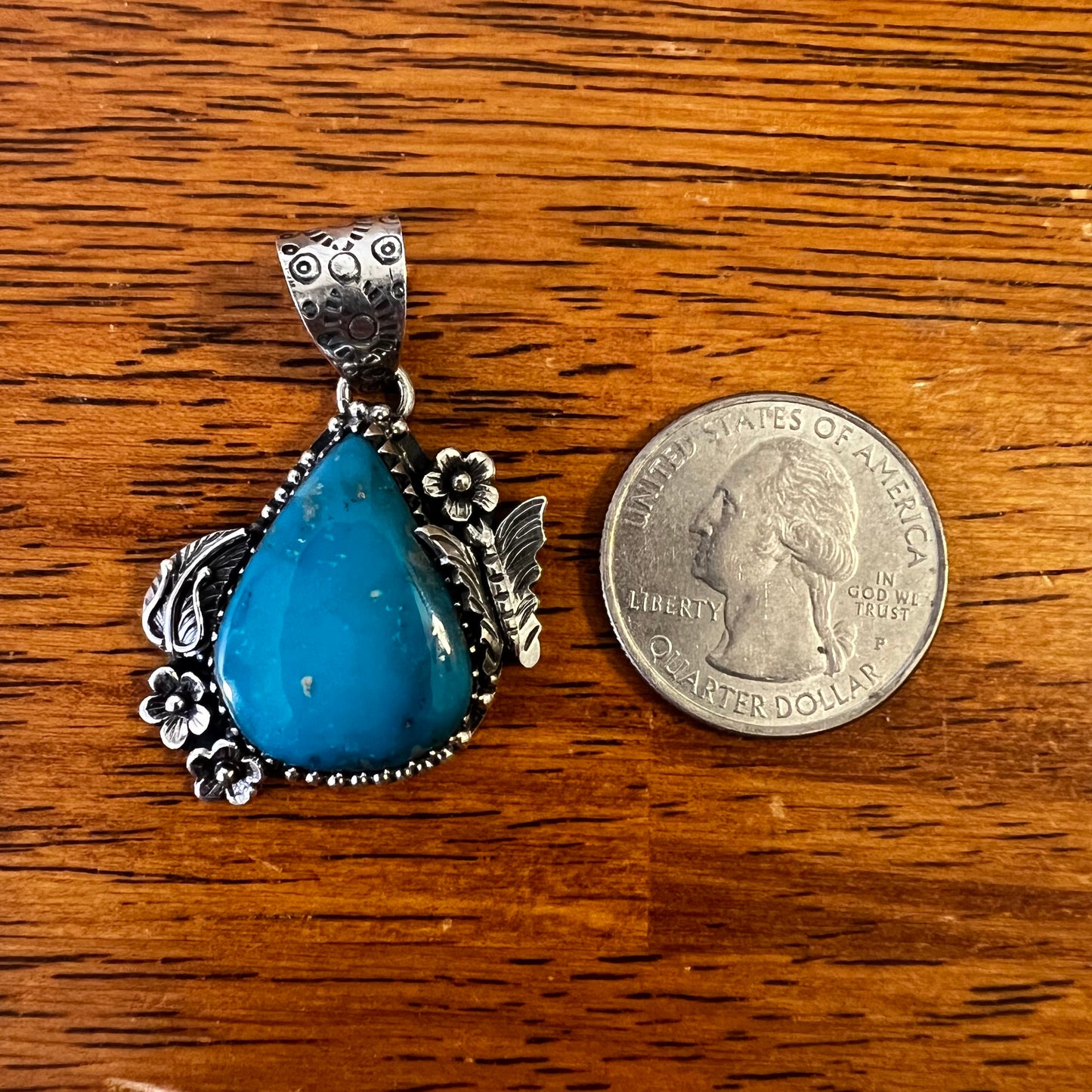 Kingman Turquoise Teardrop Pendant – Sterling Silver Floral Detail