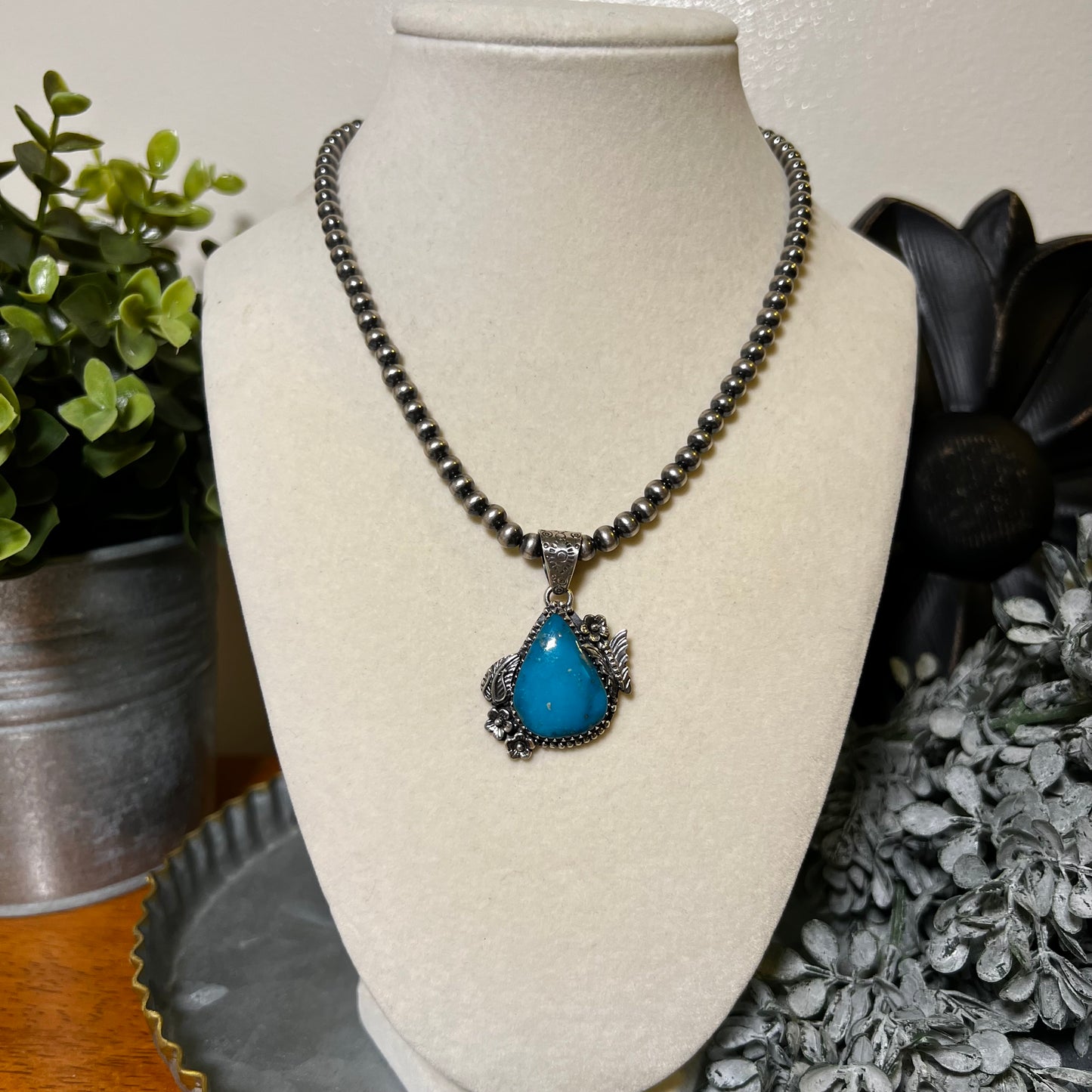 Kingman Turquoise Teardrop Pendant – Sterling Silver Floral Detail