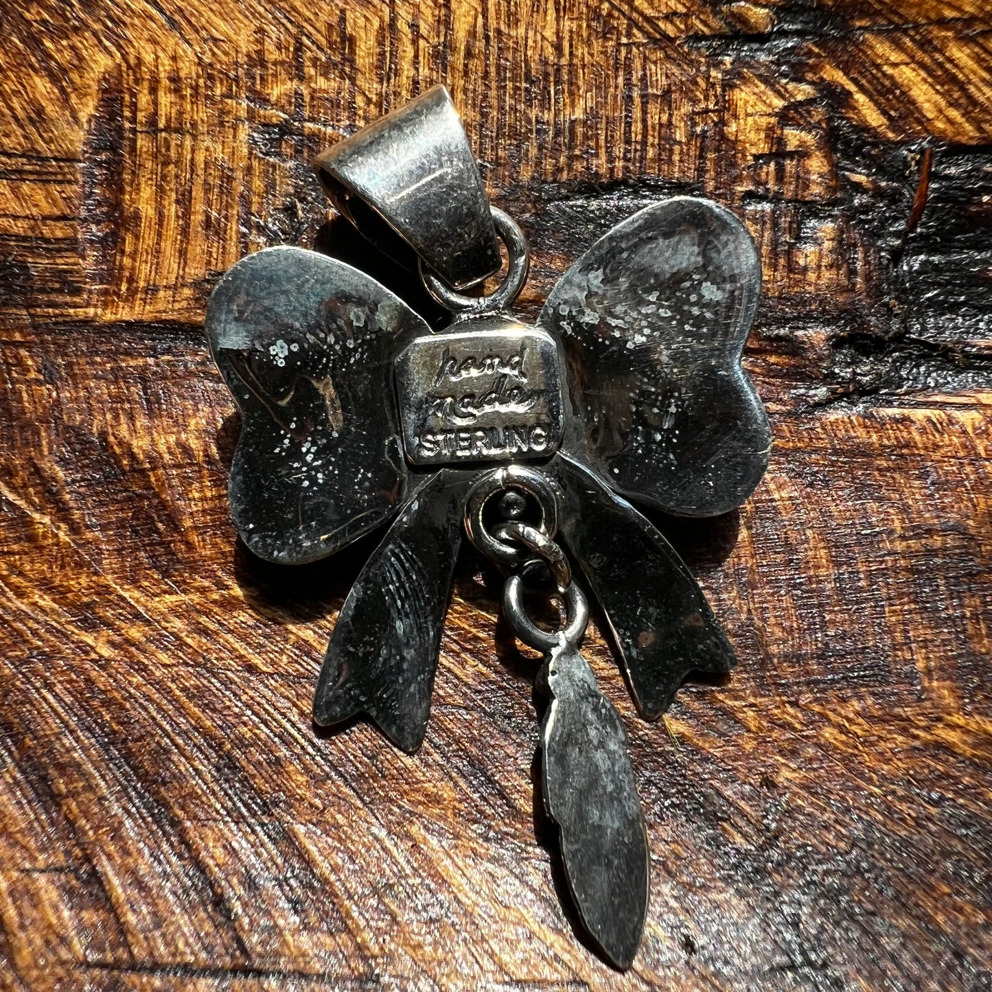Spiny Oyster Bow Pendant in Sterling Silver with Feather Drop