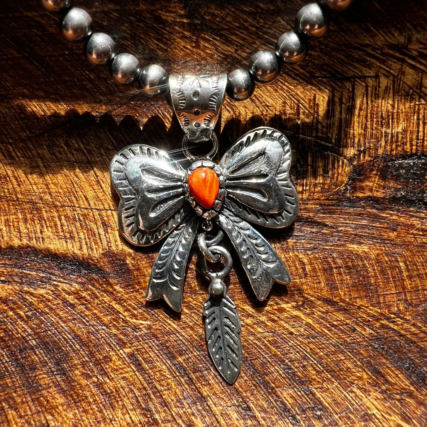 Spiny Oyster Bow Pendant in Sterling Silver with Feather Drop