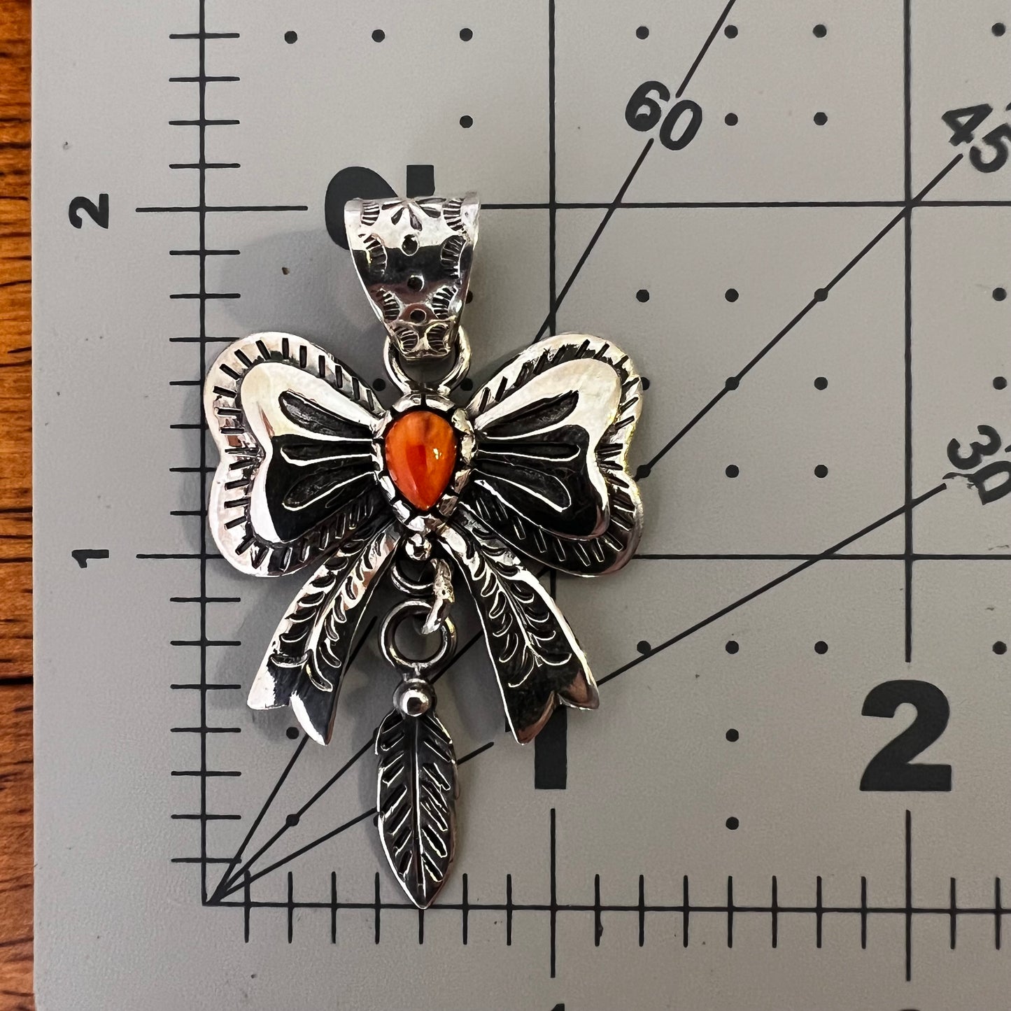Spiny Oyster Bow Pendant in Sterling Silver with Feather Drop